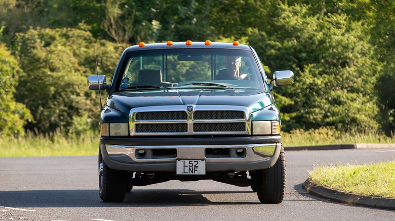 A 1994 Dodge Ram 2500 pickup truck driving on a country road