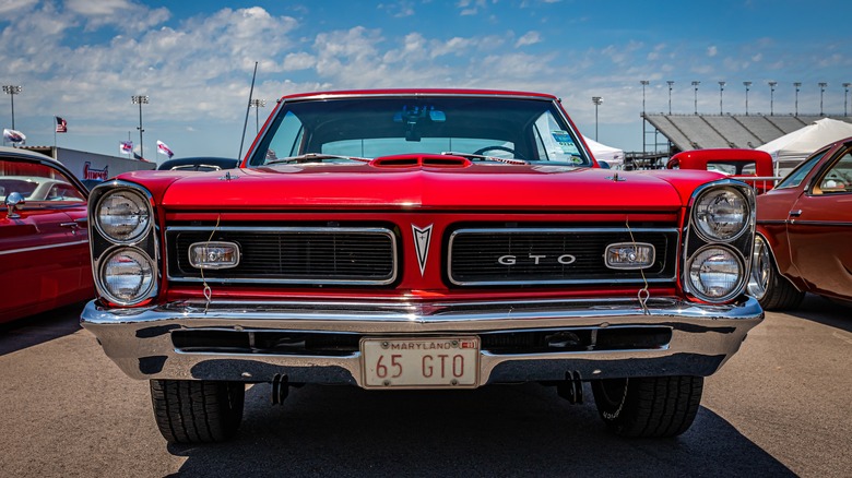 A 1965 red Pontiac LeMans GTO at a local car show