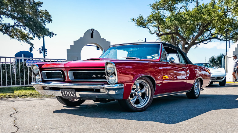 A red 1965 Pontiac Lemans GTO on a sunny day