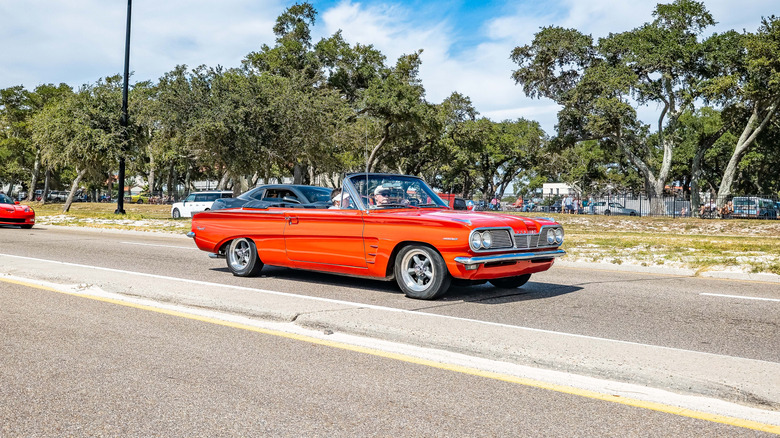 A1962 Pontiac Tempest LeMans Convertible cruising down a high way