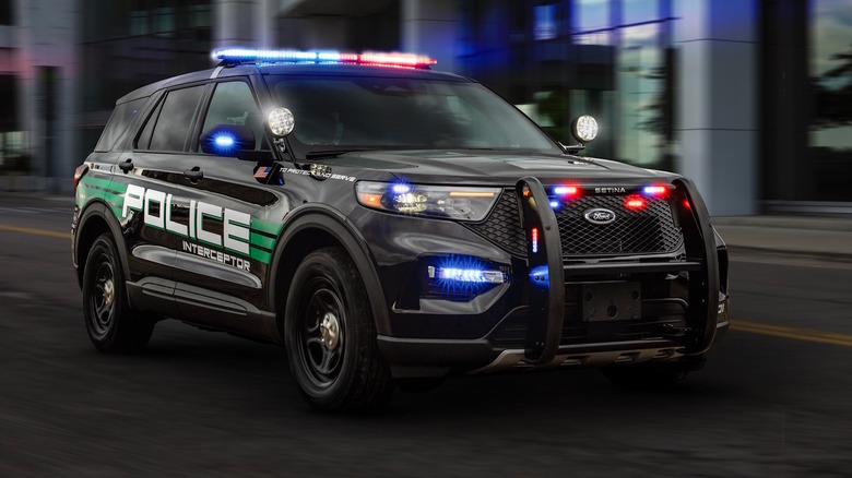 A black 2025 Ford Police Interceptor Utility with illuminated mergency lights.