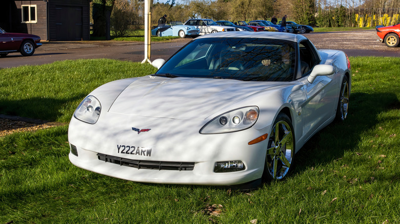 A white 2008 Chevrolet C6 Corvette parked on grass