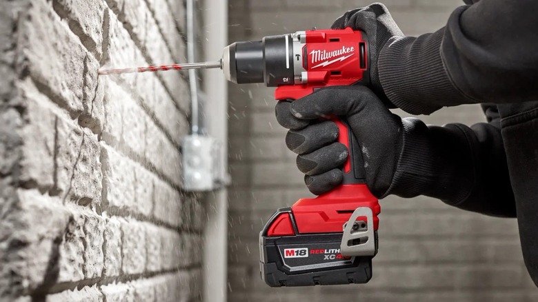 Milwaukee M18 Compact 1/2-inch Hammer Drill/Driver drilling into a wall