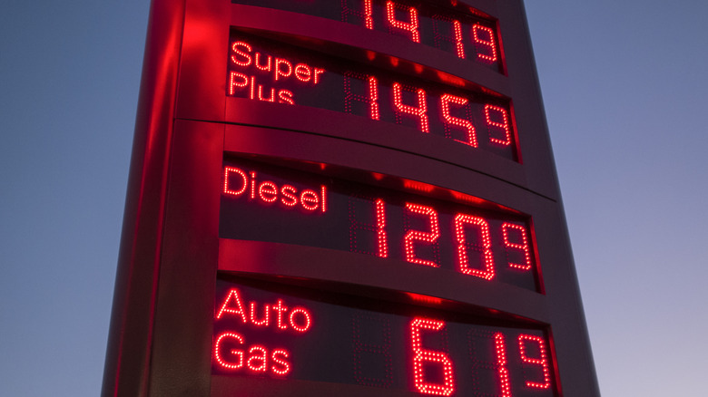 Fuel prices on a light up red sign.