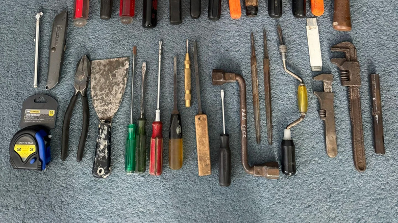 a box with its tools neatly laid out on a carpet