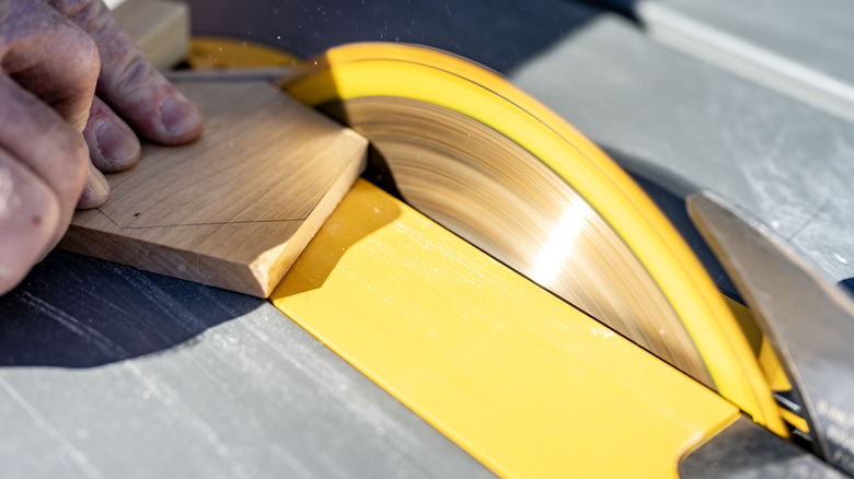 Close up of person using table saw