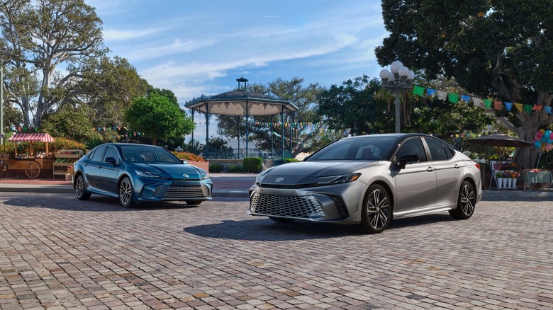Two 2025 Toyota Camry models in a park