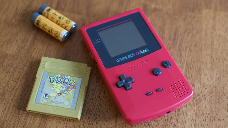 Game Boy Color with game and batteries