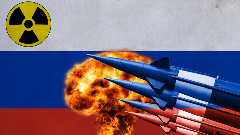Missiles preparing to fire over a backdrop of a nuclear detonation, the Russian flag, and a nuclear symbol