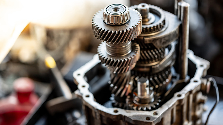Disassembled car automatic transmission gear part or gearbox on workbench in auto repair shop