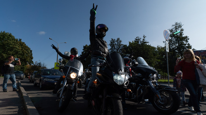 Motorcyclists showing V sign  on their bikes