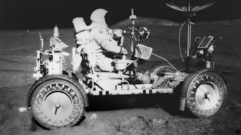 Commander of Apollo 15 David Scott drives the Lunar Rover.