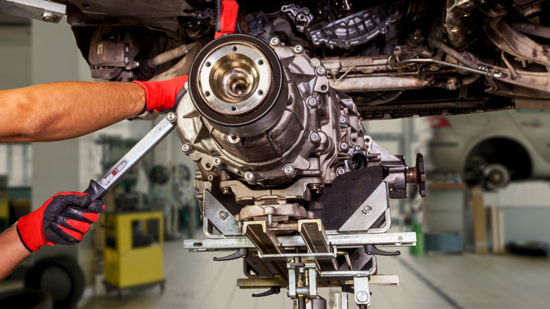 Gearbox being lowered from underneath a car