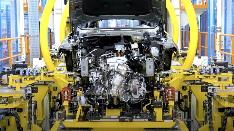 Alfa Romeo engine being installed at a manufacturing plant