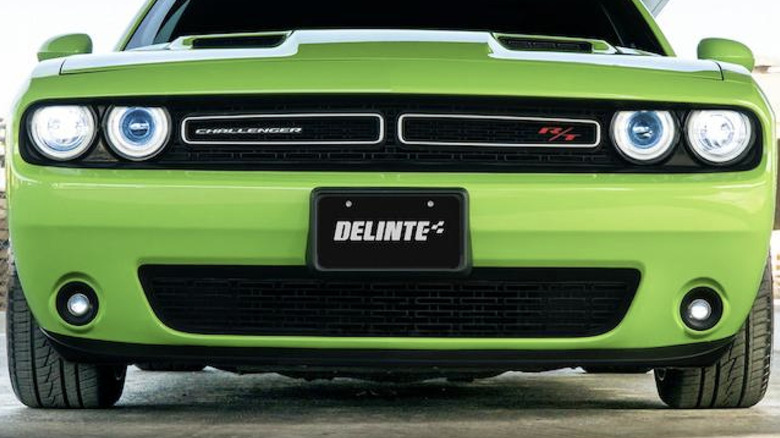 Green car with Delinte tires and license plate