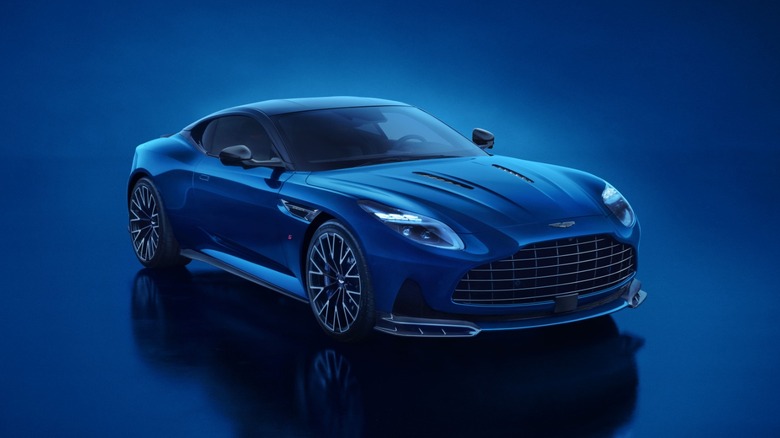 The new Aston Martin DB12 S in blue against a blue background, front 3/4 view