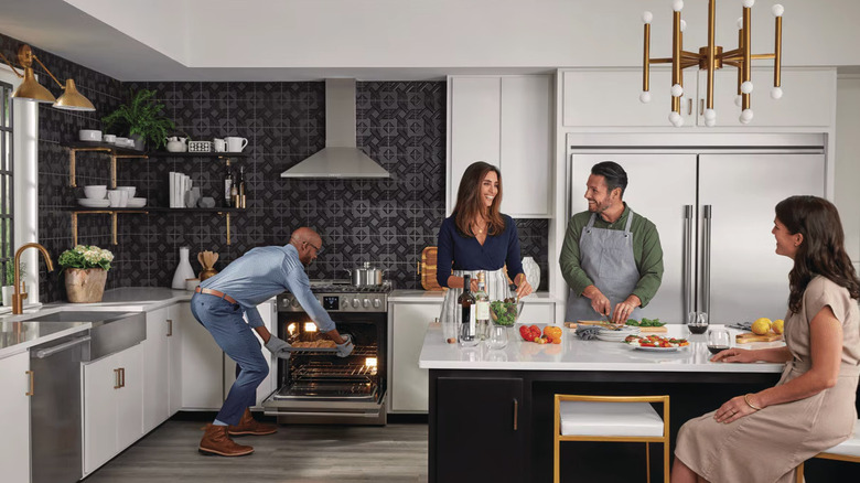 Group of people in kitchen with Frigidaire appliances