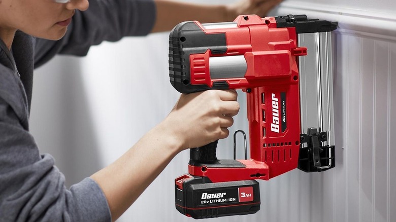 Person using Bauer nail gun