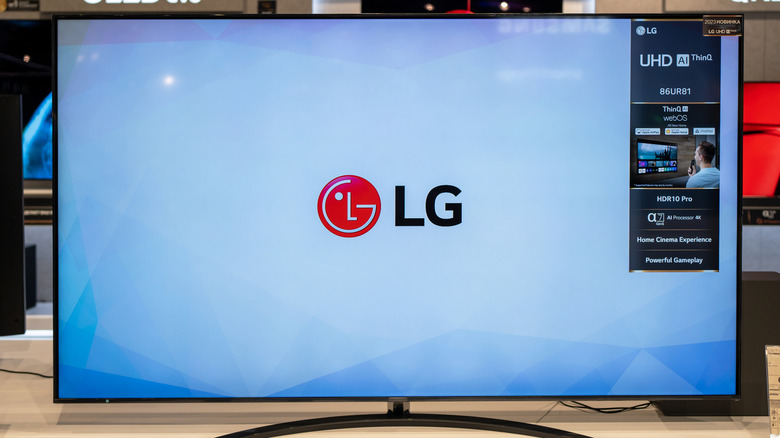 An LG UHD TV on display in a store. The LG TV is displaying the LG logo on a blue background.