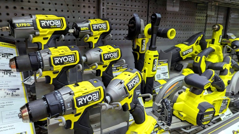 An assortment of Ryobi power tools on a store shelf.
