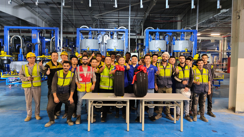 Sentury Tire factory workers holding their two inaugural tires