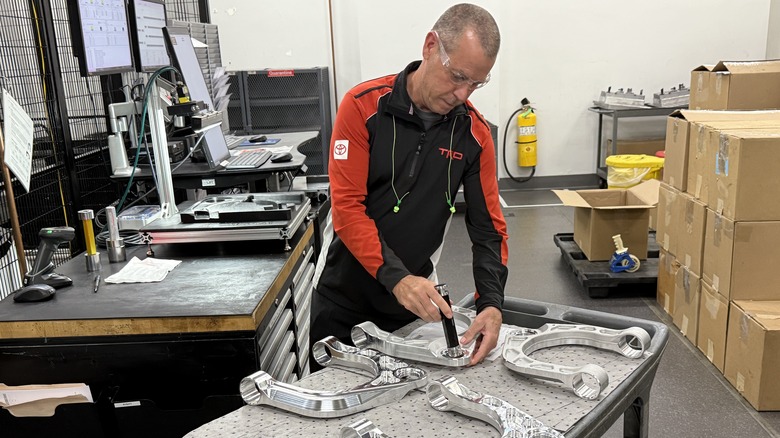 TRD employee working on suspension components