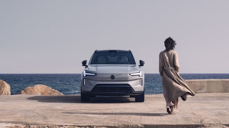 Person walking towards Volvo EX90 electric SUV