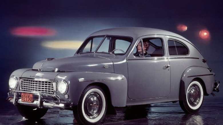 Woman sitting in Volvo PV 444 vintage model
