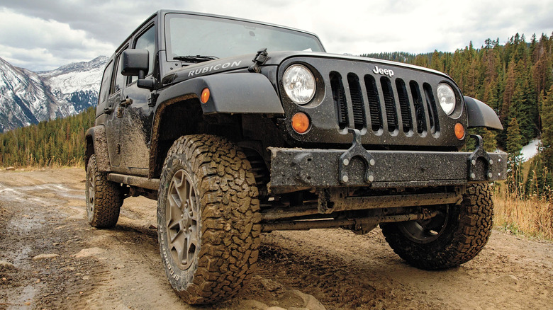 Jeep with BF Goodrich tires driving in the mud