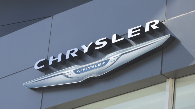 Chrysler logo hanging on the side of an auto dealership