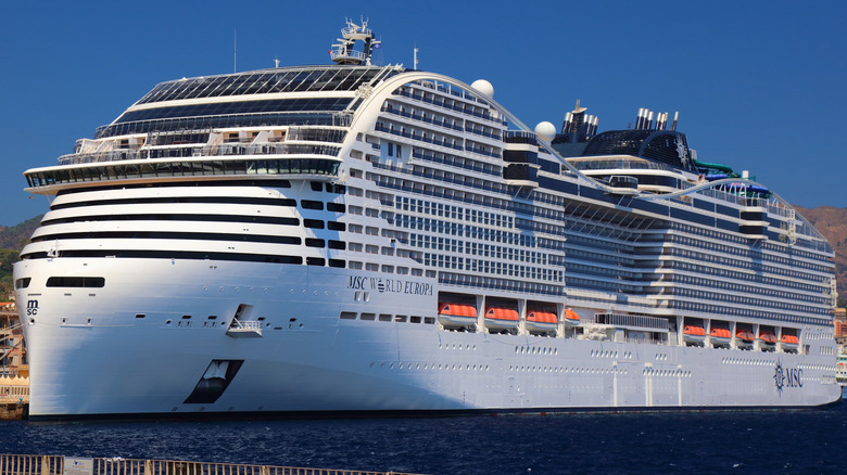 The MSC World Europa, one of the largest cruise ships in the world, docked at a port in Italy.