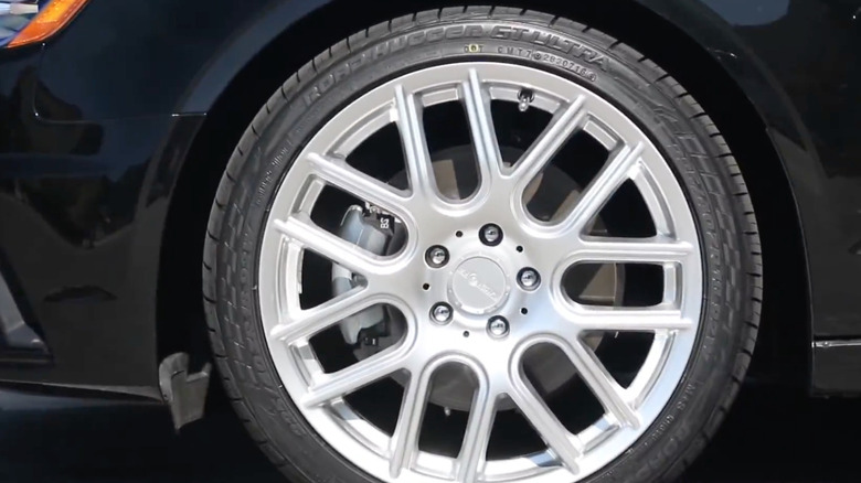 a close-up of a Road Hugger tire on a black vehicle