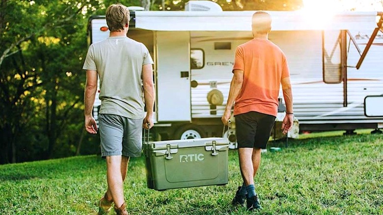 People carrying an RTIC cooler