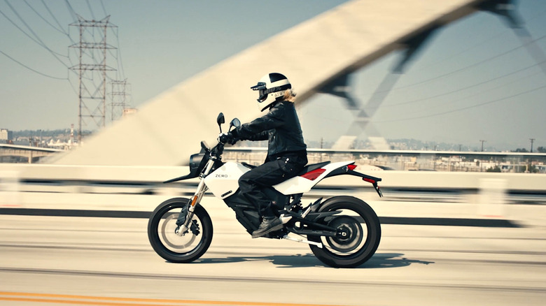 Person riding Zero Motorcycle over bridge