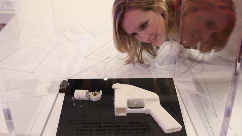 Woman observing a 3D printed gun