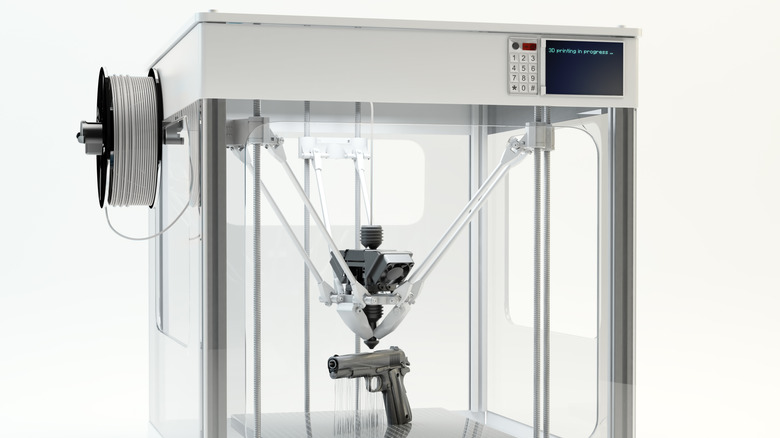 A 3D printer making a pistol.