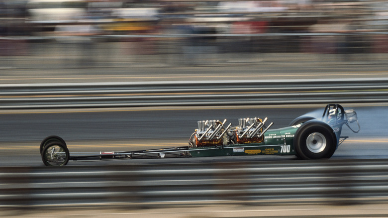 Side shot of a dragster on the strip