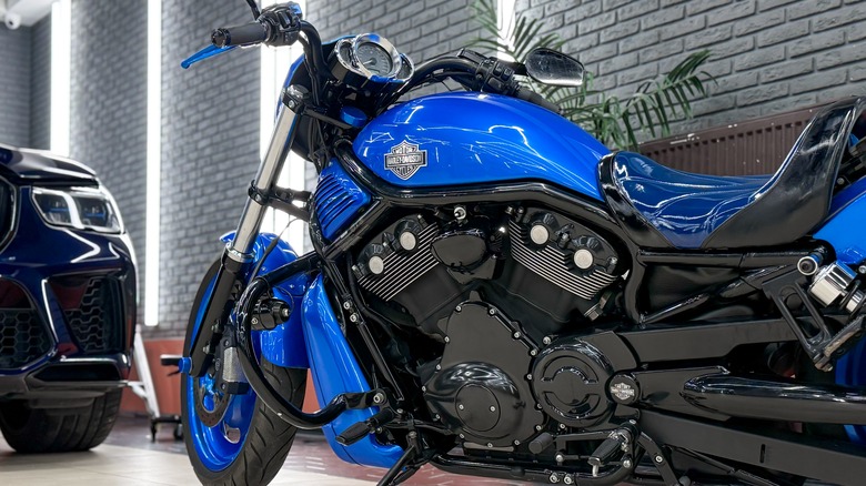 A blue and black Harley-Davidson motorcycle parked inside a showroom