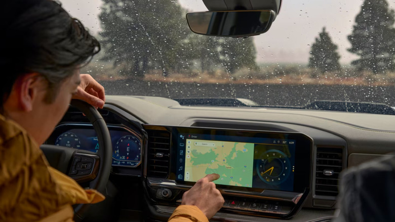 Man using the touchscreen in a Chevrolet Silverado 1500