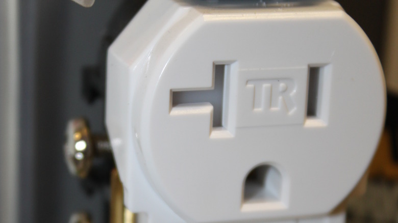 Tamper-resistant outlet showing TR marking