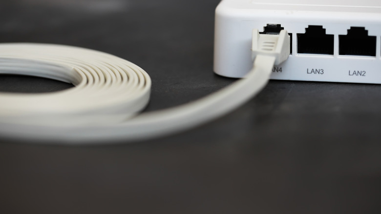 RJ45 ports on a router with a flat Ethernet cable plugged into a port