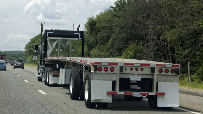 A flatbed semi-trailer with its noticeable curve