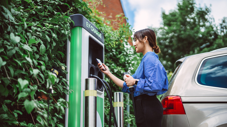 Woman charging EV