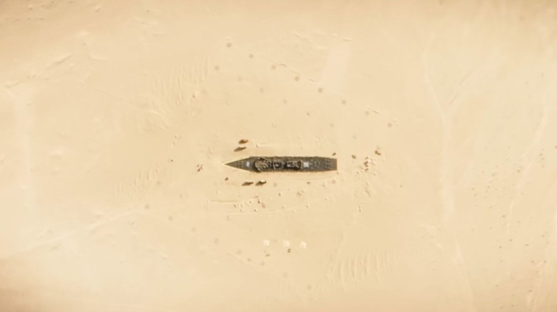 Satellite image showing a replica of the Arleigh Burke-class destroyer in the desert during the day