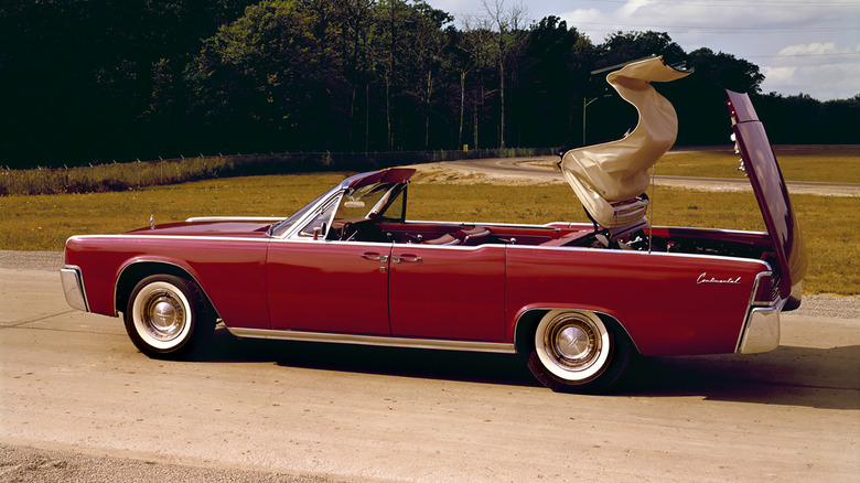 Red 1961 Lincoln Continental Convertible lowering its roof