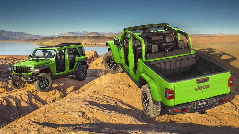 Green Jeep Gladiator and Jeep Wrangler parked on rocks