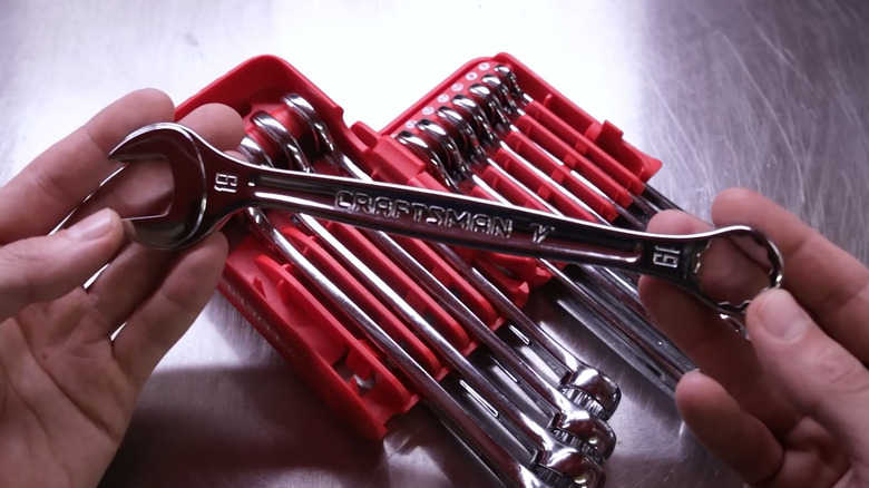 Craftsman V-Series wrench in man's hand with set in background