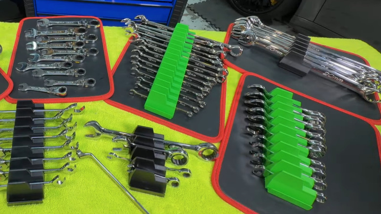 Assortment of Icon wrenches on green work bench