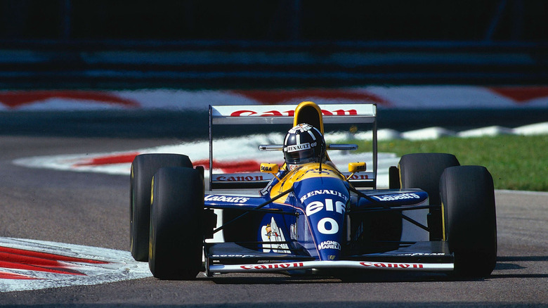 Williams FW15C Formula One car racing around circuit