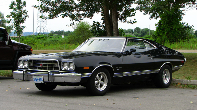 Front-quarter view of a black 1973 Ford Gran Torino parked